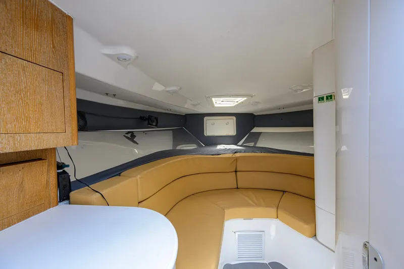 Slide: The Image of Interior of a 2009 Intrepid 370 boat with tan seating and wooden cabinetry. - 21