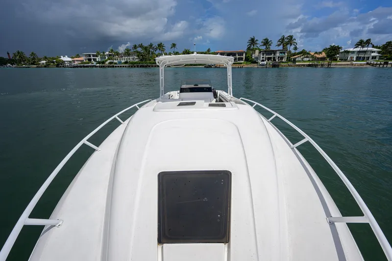 Slide: The Image of 2009 Intrepid 370 boat on calm water with coastal homes in the background. - 6