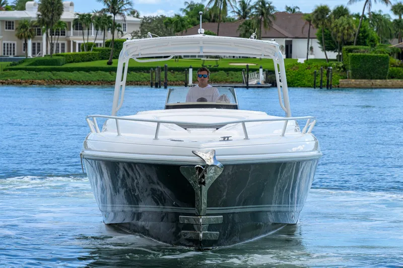 Slide: The Image of 2009 Intrepid 370 boat cruising on a scenic waterway with lush greenery. - 3