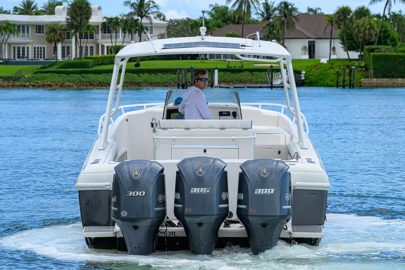 Slide: The Image of 2009 Intrepid 370 boat with triple Yamaha 300 engines cruising on a scenic waterway. - 4