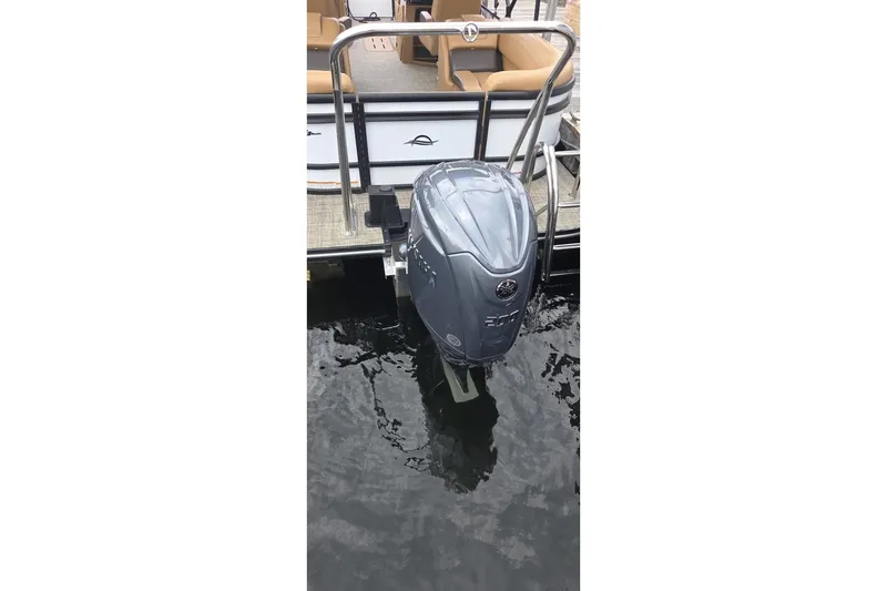 Slide: The Image of Outboard motor on 2025 SunCatcher 324 Rc Fusion pontoon boat, docked on water. - 4