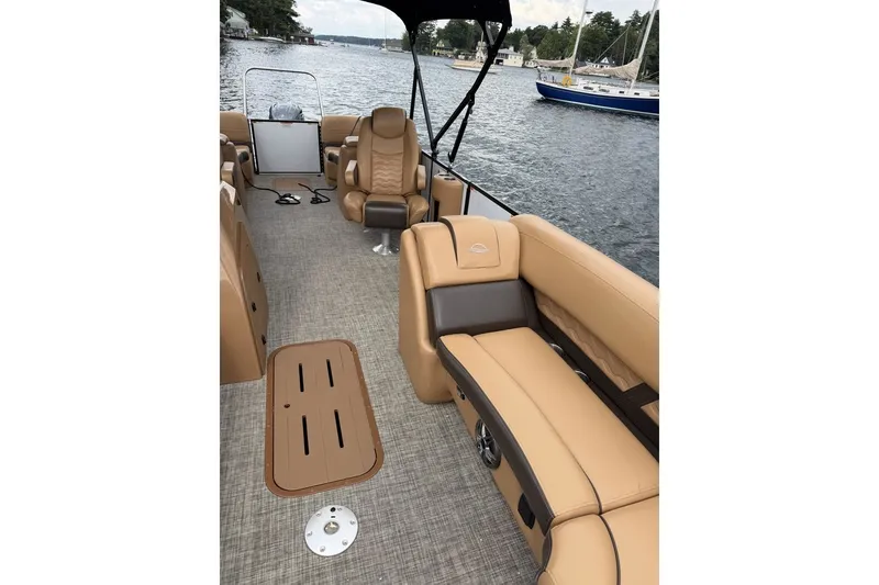 Slide: The Image of Interior of 2025 SunCatcher 324 Rc Fusion boat with tan seating on a lake. - 6