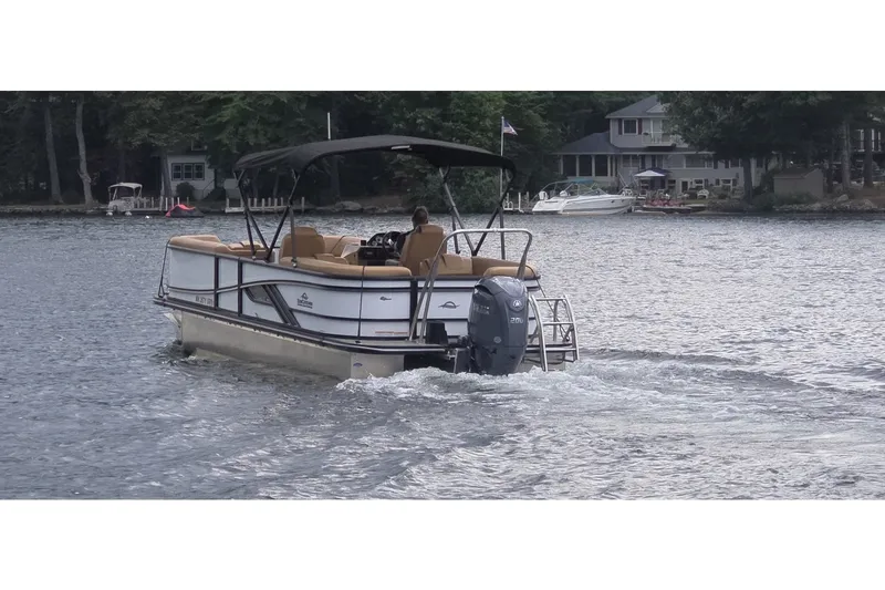 Slide: The Image of 2025 SunCatcher 324 Rc Fusion pontoon boat cruising on a serene lake. - 3