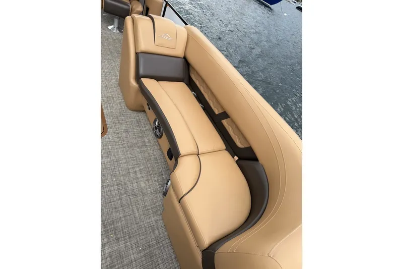 Slide: The Image of Luxurious tan seating on 2025 SunCatcher 324 Rc Fusion boat by the water. - 5