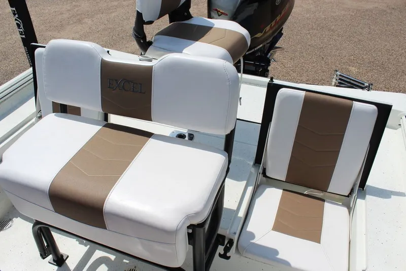 Slide: The Image of 2025 Excel 220 Bay Pro Elite boat seats with white and brown upholstery. - 13