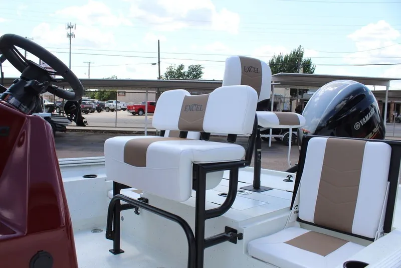 Slide: The Image of 2025 Excel 220 Bay Pro Elite boat interior with Yamaha engine and cushioned seating. - 6