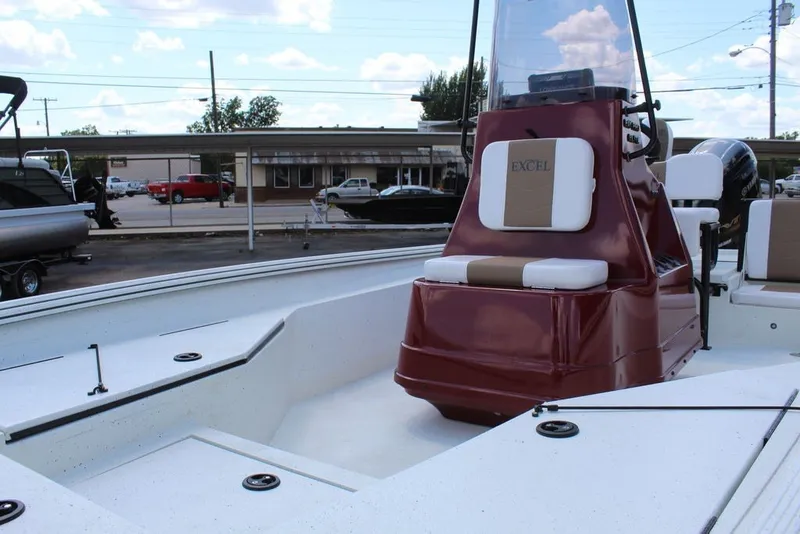 Slide: The Image of 2025 Excel 220 Bay Pro Elite boat with maroon console and white seating. - 5