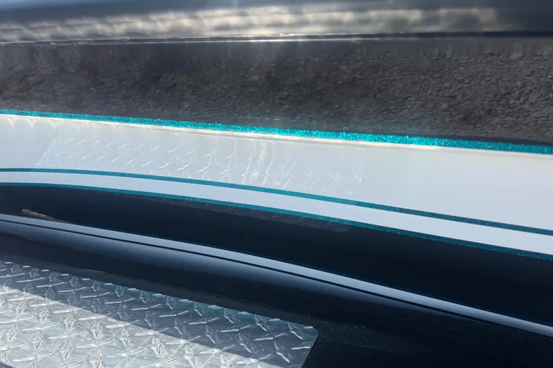 Slide: The Image of Close-up of 2027 Phoenix 720 ZXL boat with sleek design and metallic accents. - 11