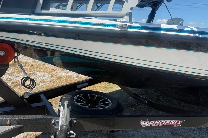 Slide: The Image of 2027 Phoenix 720 ZXL boat on trailer, showcasing sleek design and branding. - 5