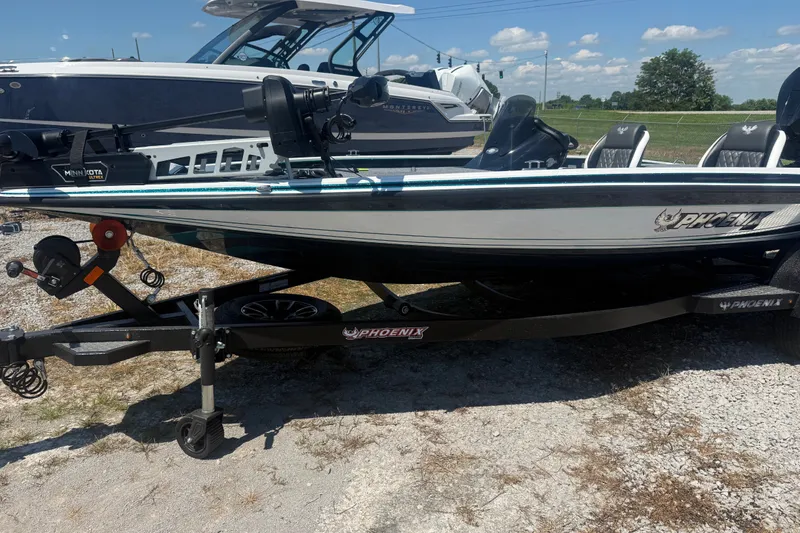 Slide: The Image of 2027 Phoenix 720 ZXL boat on trailer, parked outdoors under a clear sky. - 4