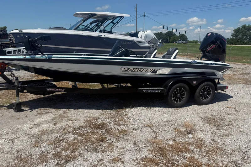 Slide: The Image of 2027 Phoenix 720 ZXL boat on trailer, parked outdoors under a clear sky. - 3
