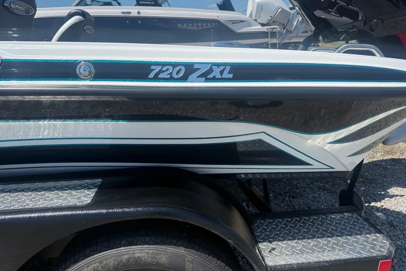 Slide: The Image of 2027 Phoenix 720 ZXL boat side view with sleek design and branding. - 10