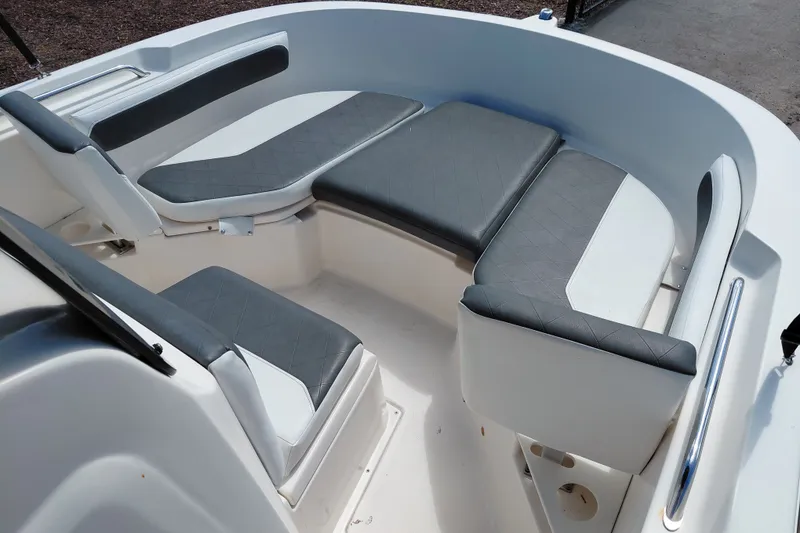 Slide: The Image of 2020 Bayliner Trophy T20CC boat interior with cushioned seating and sleek design. - 15