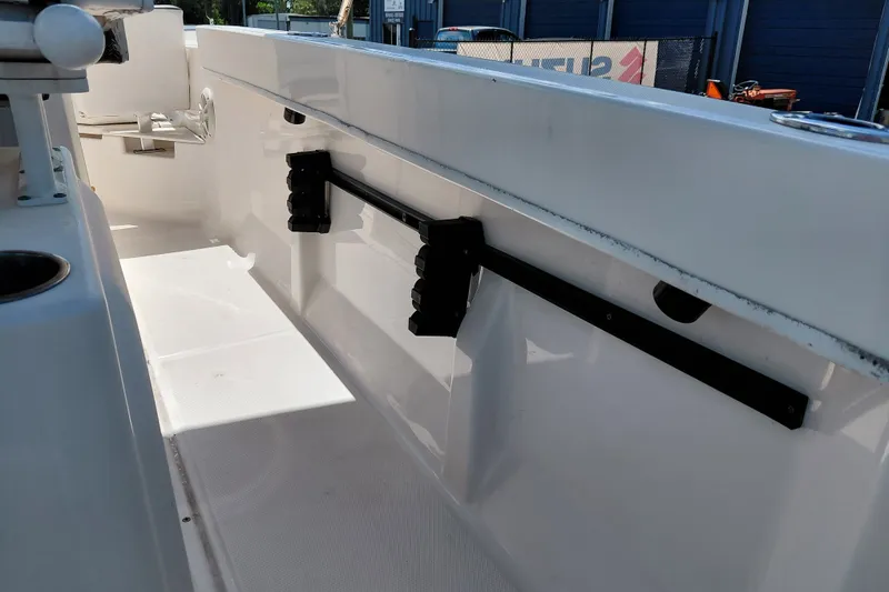 Slide: The Image of 2020 Bayliner Trophy T20CC boat interior with rod holders and seating area. - 37