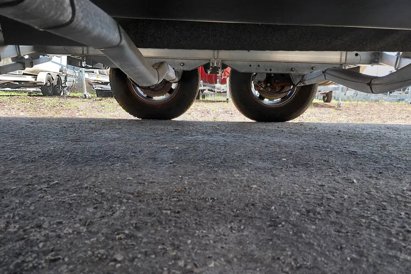 Slide: The Image of Underneath view of a 2020 Bayliner Trophy T20CC trailer with dual wheels. - 41