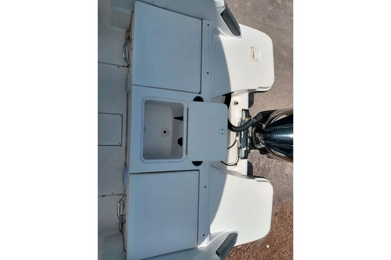 Slide: The Image of 2020 Bayliner Trophy T20CC boat deck with storage compartments and outboard motor. - 35
