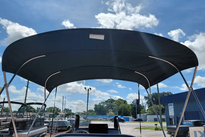 Slide: The Image of 2020 Bayliner Trophy T20CC boat with black bimini top under blue sky. - 32