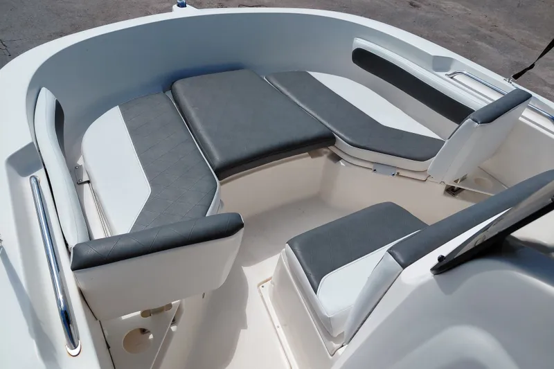 Slide: The Image of 2020 Bayliner Trophy T20CC boat interior with cushioned seating and sleek design. - 14