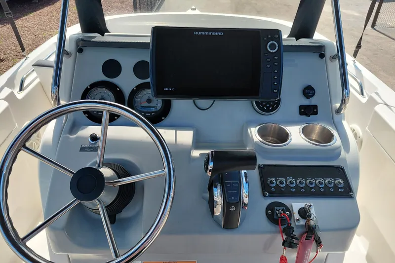 Slide: The Image of 2020 Bayliner Trophy T20CC helm with steering wheel, gauges, and navigation system. - 19