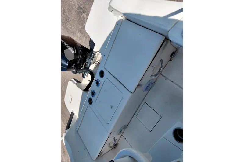 Slide: The Image of 2020 Bayliner Trophy T20CC boat interior with Mercury engine, featuring storage compartments. - 27