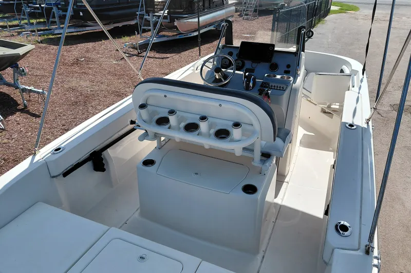 Slide: The Image of 2020 Bayliner Trophy T20CC boat interior with helm, seating, and rod holders. - 29