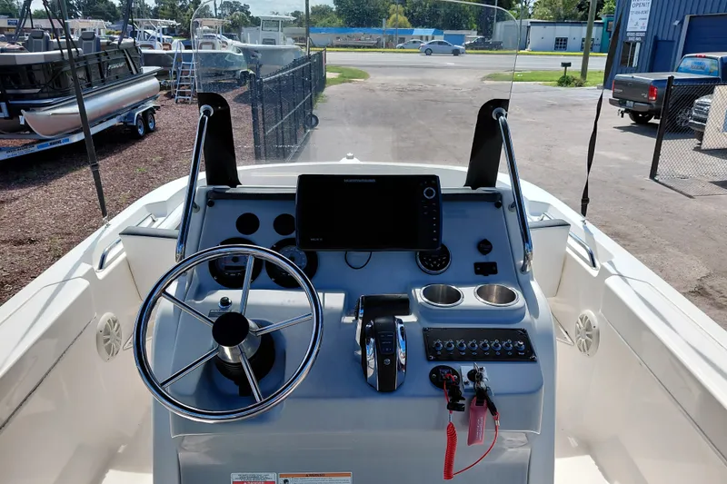 Slide: The Image of 2020 Bayliner Trophy T20CC boat dashboard with steering wheel and controls. - 17