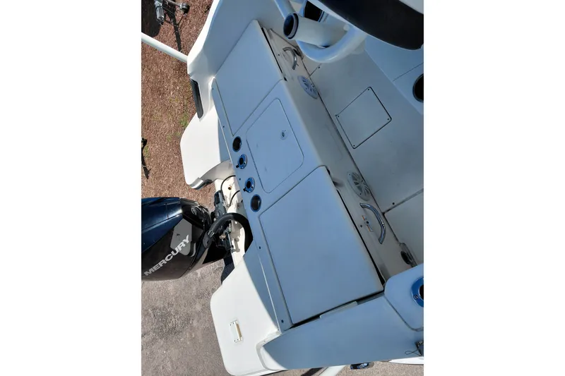 Slide: The Image of 2020 Bayliner Trophy T20CC boat deck with Mercury engine, featuring storage compartments. - 26