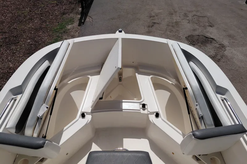 Slide: The Image of 2020 Bayliner Trophy T20CC boat interior with open storage compartments. - 16