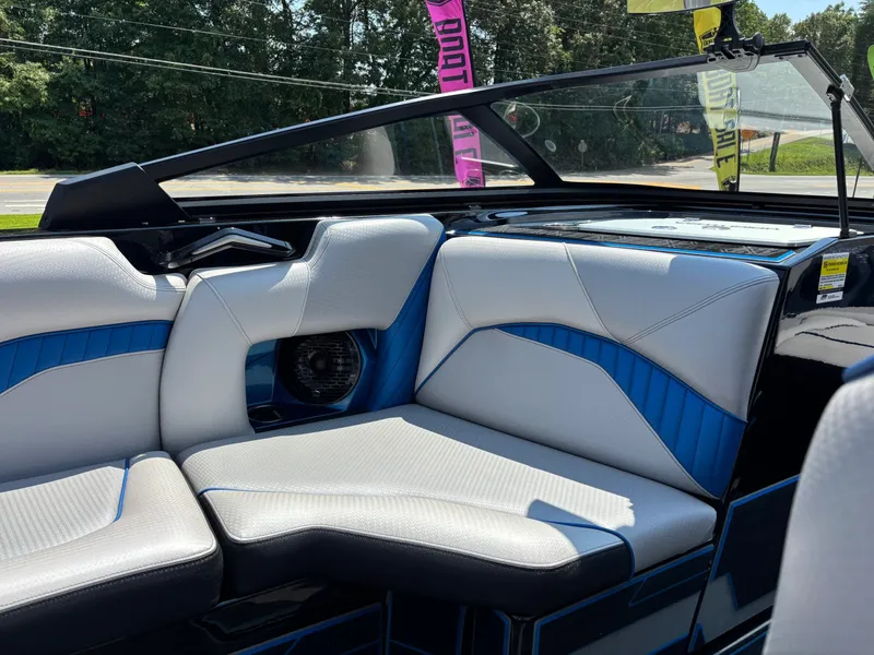 Slide: The Image of The image shows the luxurious interior of a 2023 Centurion Fi25 with modern blue and white seating. - 13