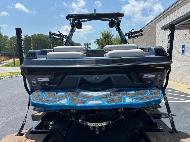 Slide: The Image of The image shows a 2023 Centurion Fi25 boat with blue accents and two white seats. - 5