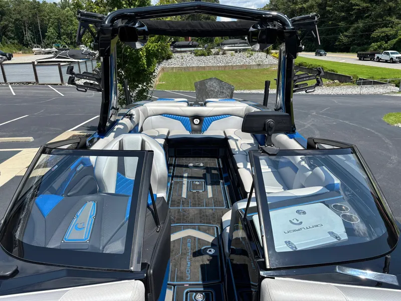 Slide: The Image of The image shows a modern 2023 Centurion Fi25 boat with stylish blue and black interior. - 10