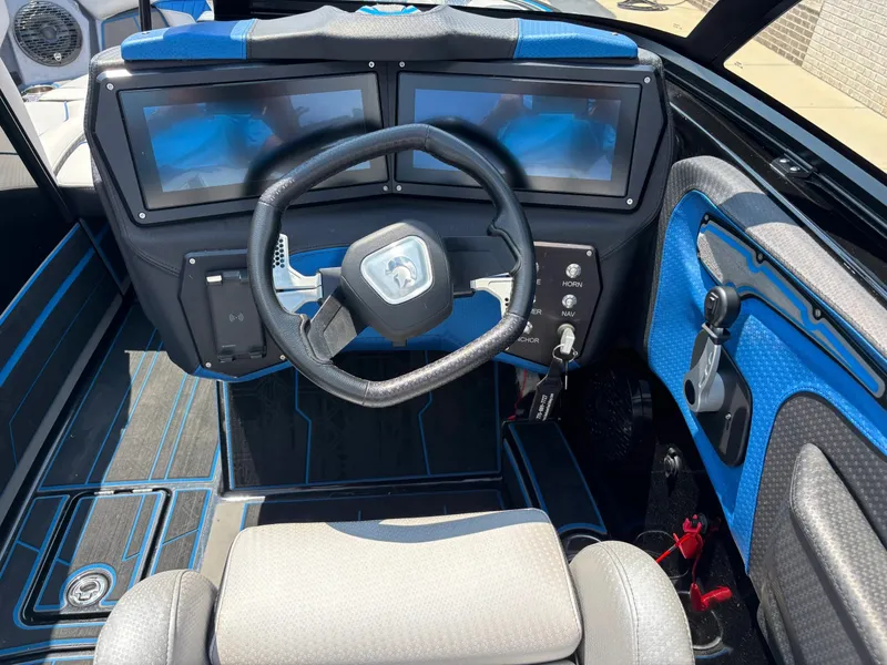 Slide: The Image of The cockpit of a 2023 Centurion Fi25 with a modern steering wheel and two large screens. - 12