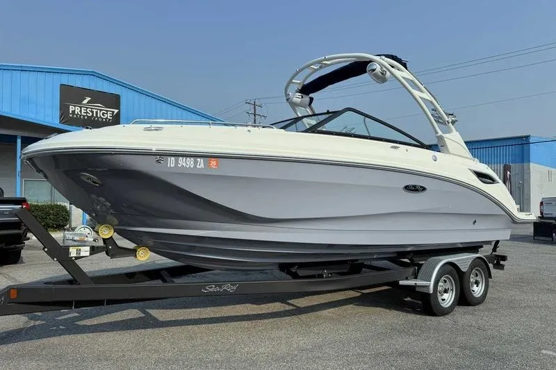 Slide: The Image of 2022 Sea Ray SDX 250 boat on trailer at dealership, showcasing sleek design. - 14