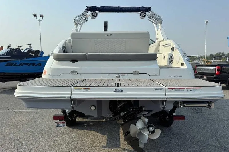 Slide: The Image of 2022 Sea Ray SDX 250 boat rear view with swim platform and propeller. - 8