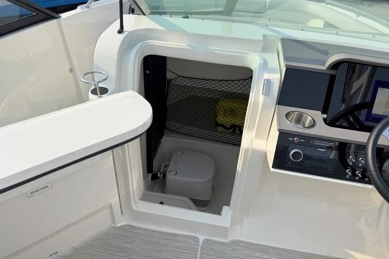 Slide: The Image of 2022 Sea Ray SDX 250 boat interior with compact toilet compartment. - 4