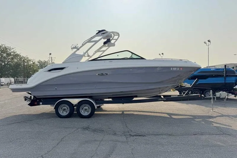 Slide: The Image of 2022 Sea Ray SDX 250 boat on trailer in parking lot, side view. - 12