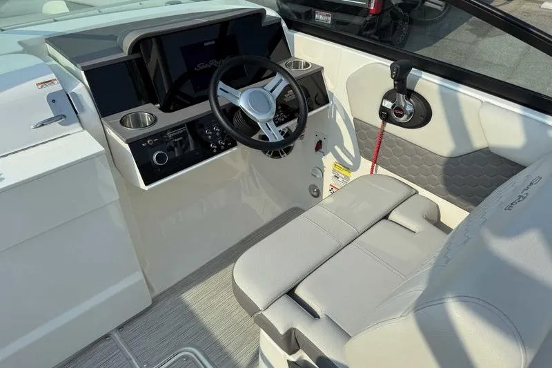 Slide: The Image of 2022 Sea Ray SDX 250 boat cockpit with steering wheel and control panel. - 18