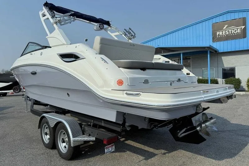 Slide: The Image of 2022 Sea Ray SDX 250 boat on trailer outside Prestige Water Sports building. - 10