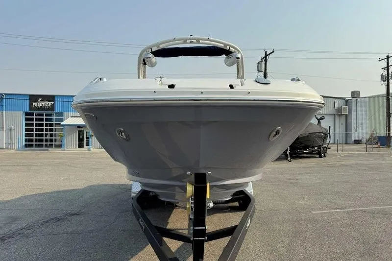 Slide: The Image of 2022 Sea Ray SDX 250 boat on trailer in industrial area. - 13