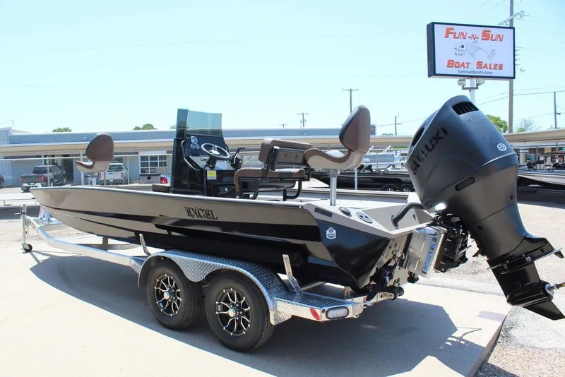 Slide: The Image of 2027 Excel 220 Bay Pro Elite boat on trailer at dealership, featuring Suzuki outboard motor. - 15