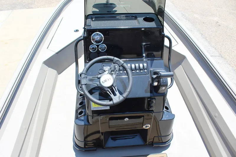 Slide: The Image of 2027 Excel 220 Bay Pro Elite boat console with steering wheel and controls. - 7