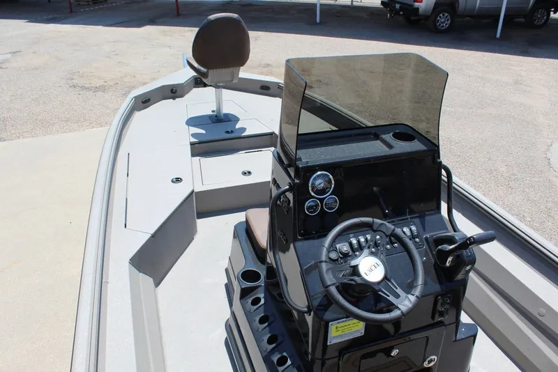 Slide: The Image of 2027 Excel 220 Bay Pro Elite boat interior with steering console and seating. - 16