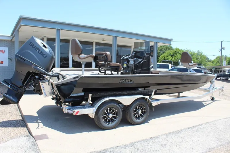 Slide: The Image of 2027 Excel 220 Bay Pro Elite boat on trailer, featuring Suzuki outboard motor. - 2