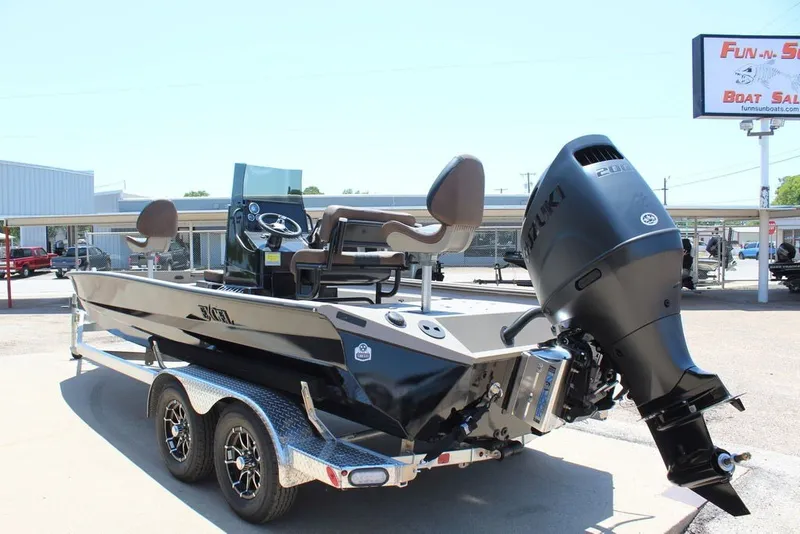 Slide: The Image of 2027 Excel 220 Bay Pro Elite boat on trailer with powerful outboard motor. - 5