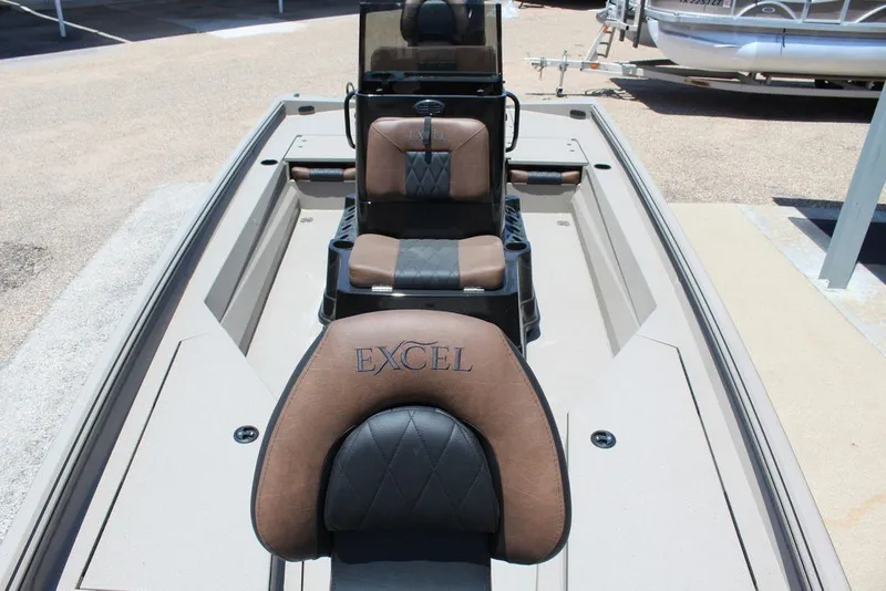 Slide: The Image of 2027 Excel 220 Bay Pro Elite boat interior with brown and black seating. - 8