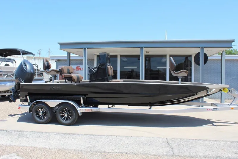 Slide: The Image of 2027 Excel 220 Bay Pro Elite boat on trailer, parked outside a building. - 3
