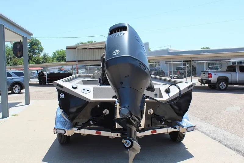 Slide: The Image of 2027 Excel 220 Bay Pro Elite boat with powerful outboard motor on trailer. - 4