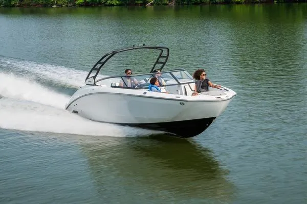 The Image of 2026 Yamaha Boats 252S cruising on a serene lake with passengers enjoying the ride. - 2