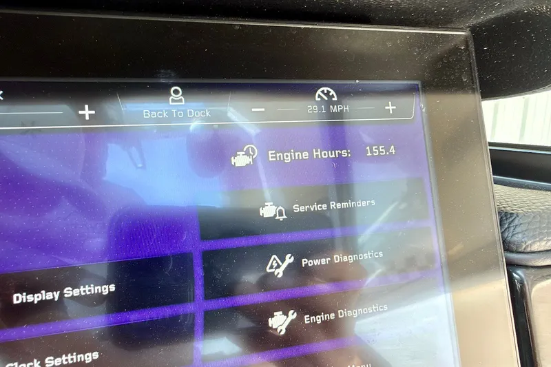 Slide: The Image of 2023 Nautique Super Air Nautique S23 dashboard displaying engine hours and diagnostics. - 16