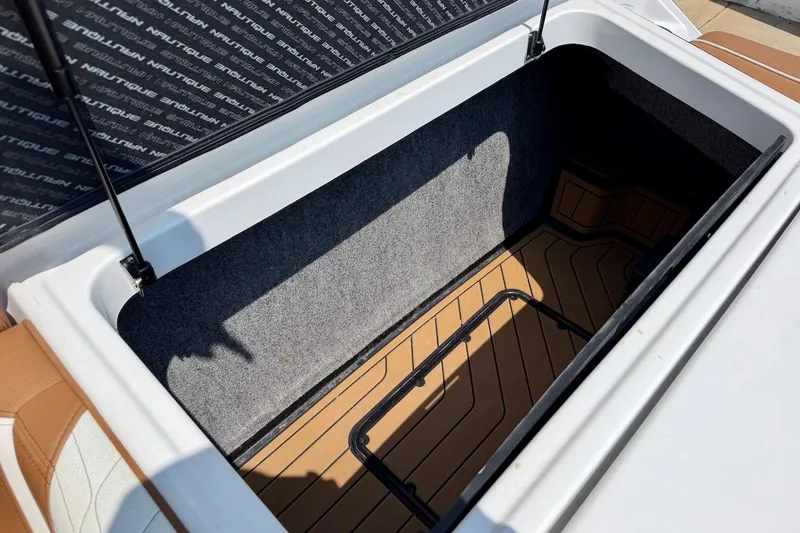 Slide: The Image of 2023 Nautique Super Air Nautique S23 storage compartment with open lid, showcasing interior space. - 28